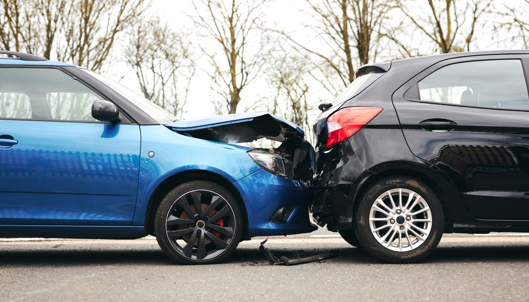 A blue car and a black car in a fender-bender accident.