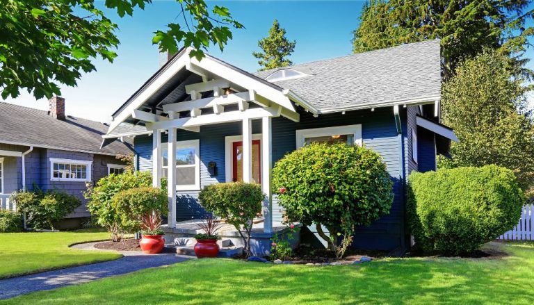 An exterior view of a blue bungalow home.