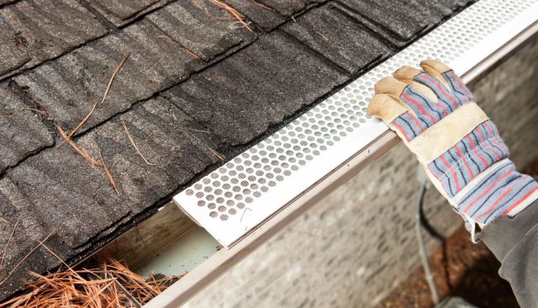 A person installing gutter guards.